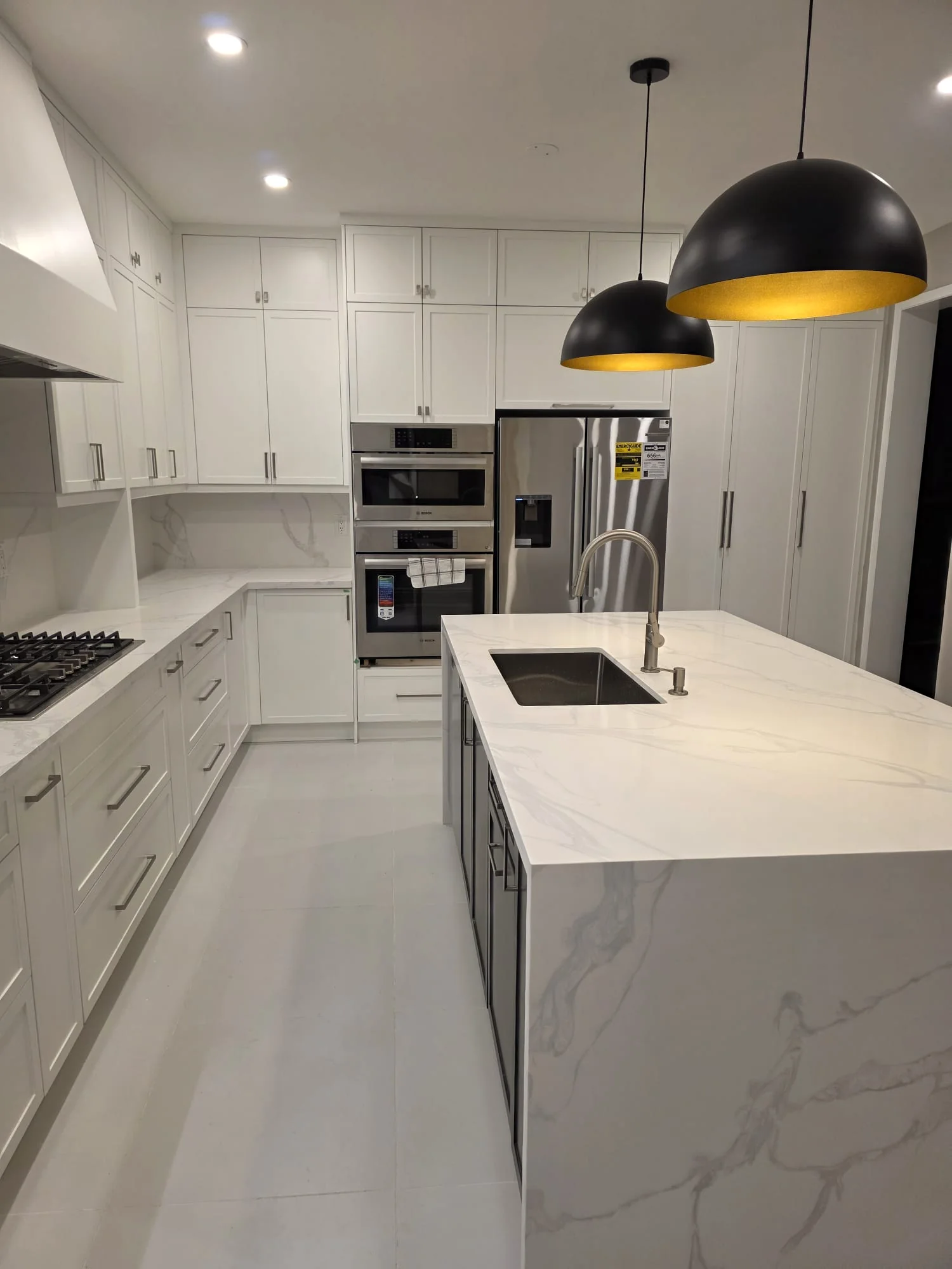 Precisely fitted custom kitchen cabinets, stone counters and island millwork